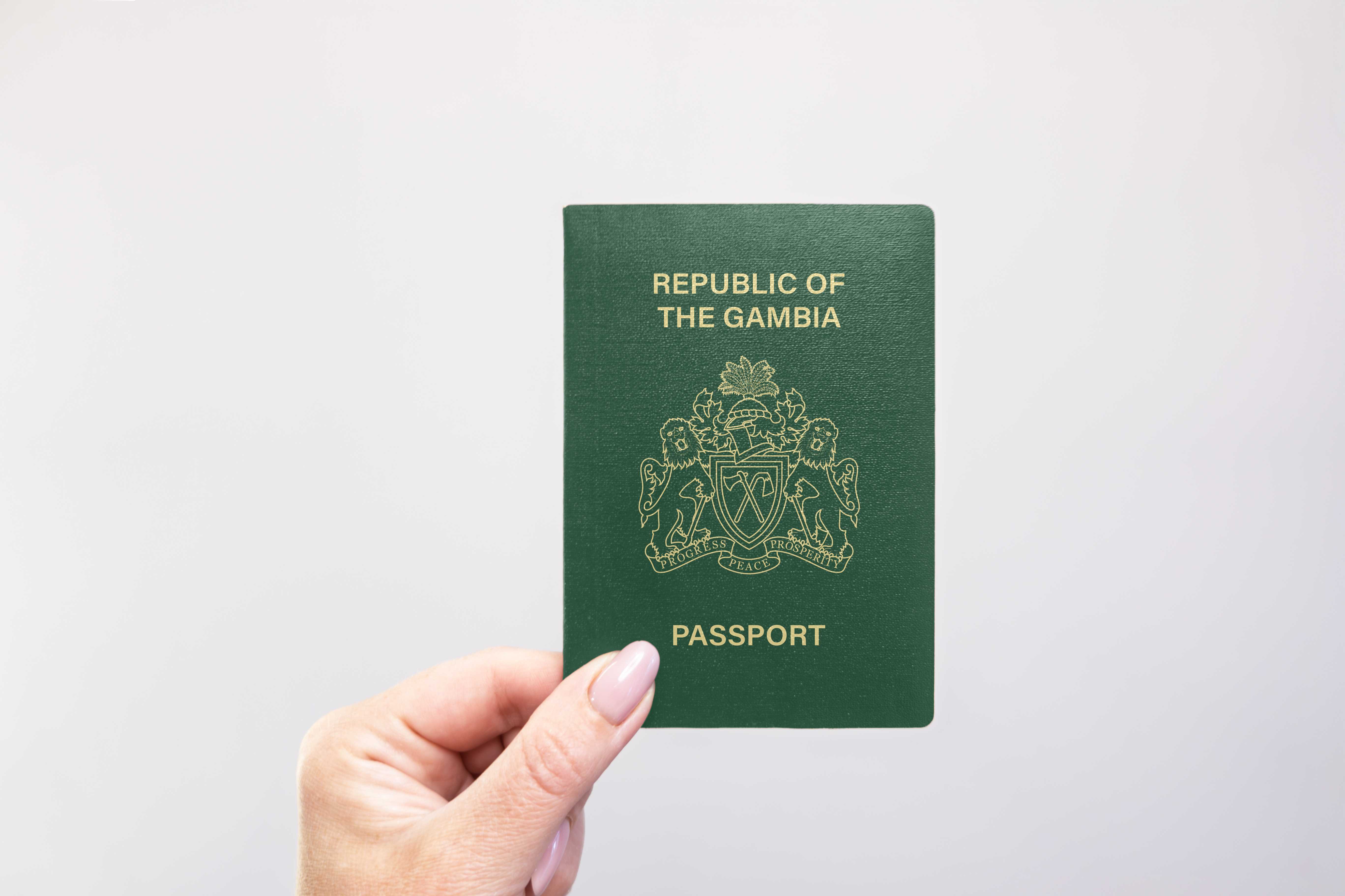 Close Up Of A Gambia Passport Held In Hand
