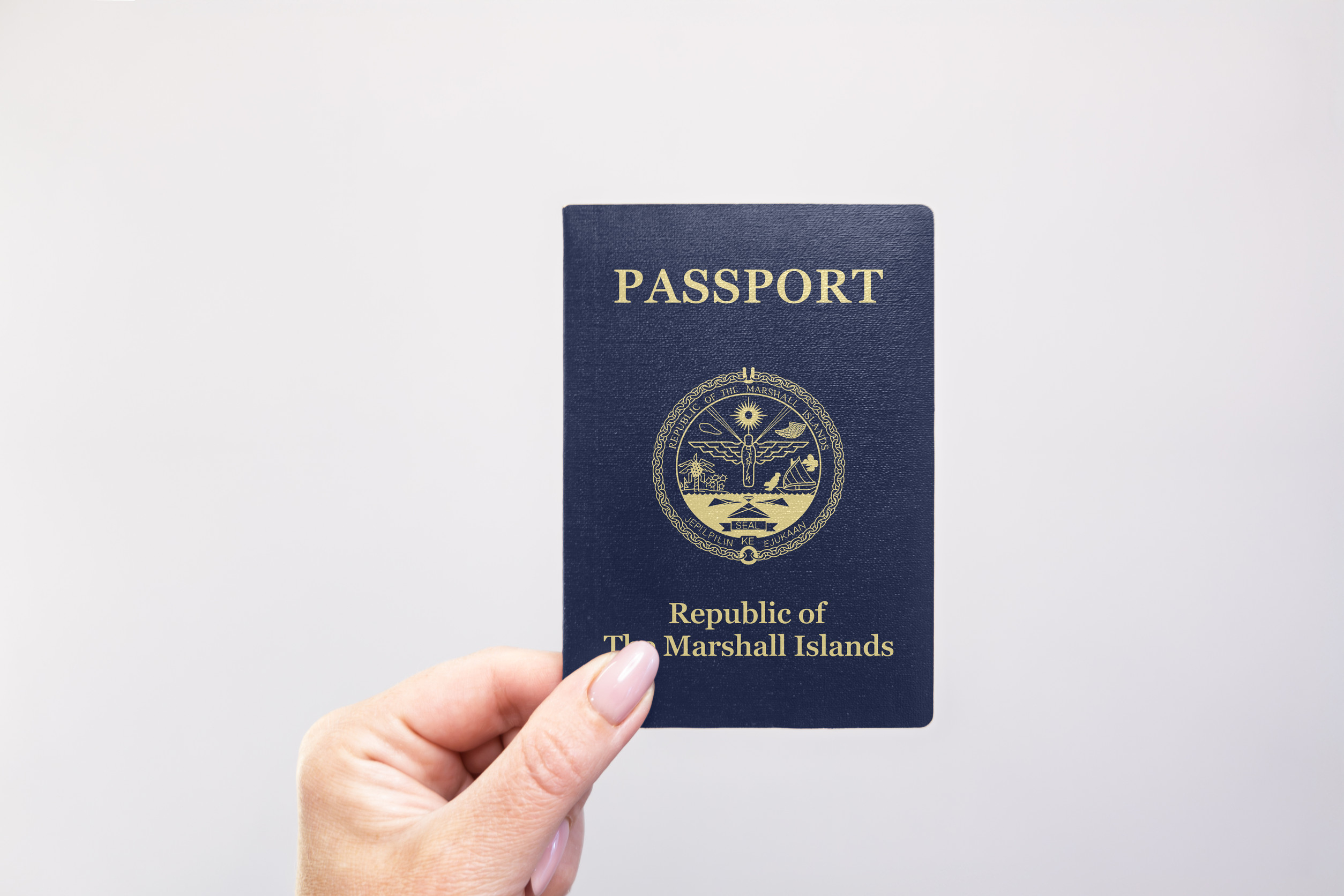 Marshall Islands Passport Held In Hand Against A Plain