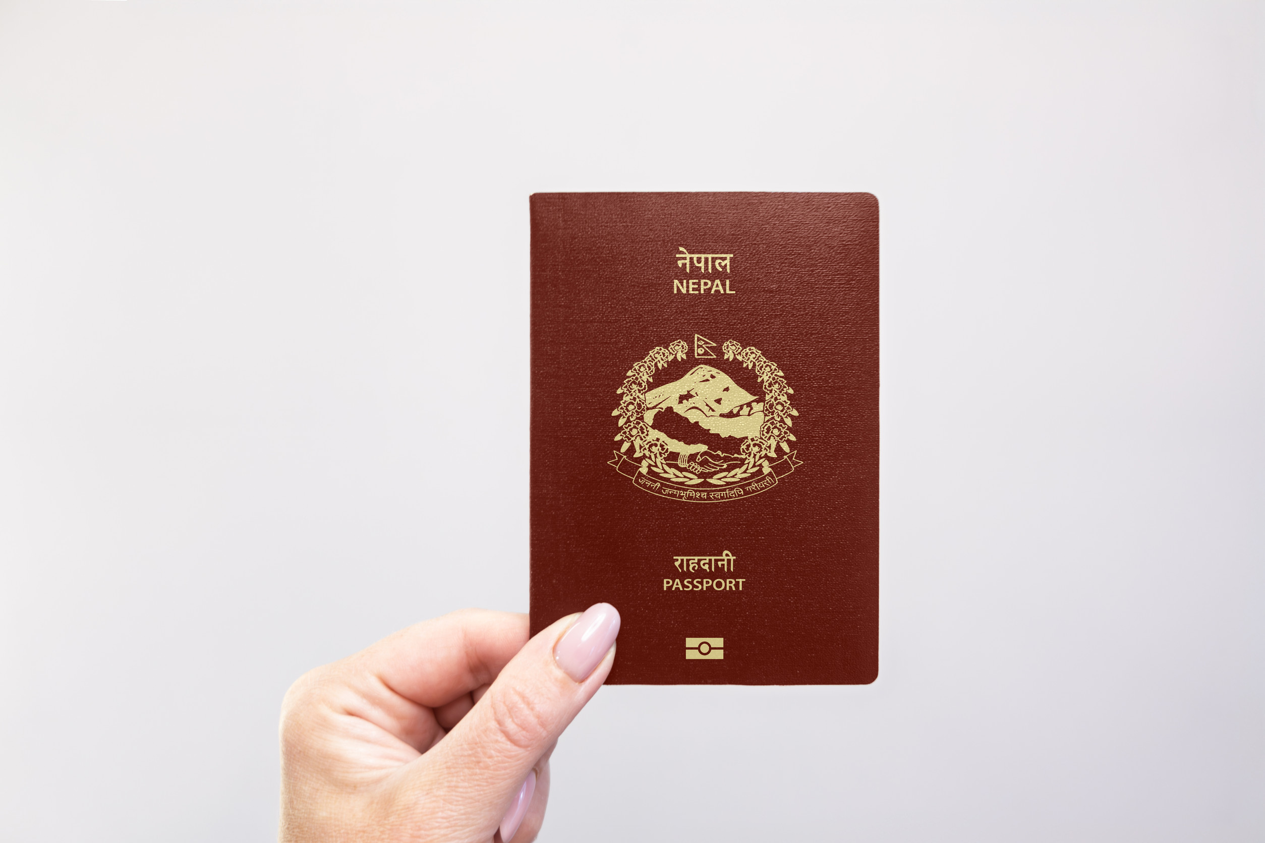 Nepal Held Passport In Hand Against A Plain